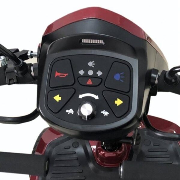 Close-up van het bedieningspaneel van de Kymco New Super 8 4-wiel scooter met knoppen voor de claxon, koplampen, alarmlichten en richtingspijlen, gemonteerd op een rode scooter.